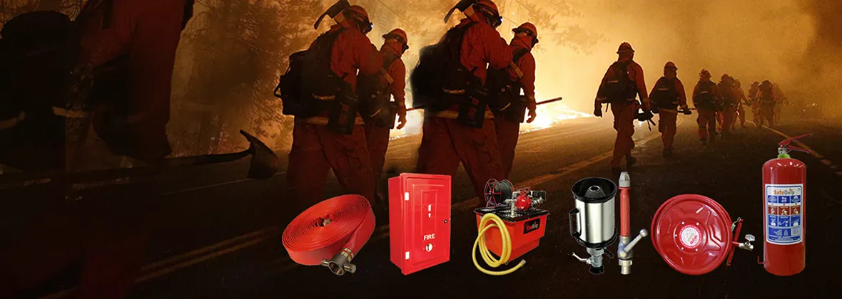 Firefighters walking through smoke, with extinguishers, hose reels and hoses in the foreground